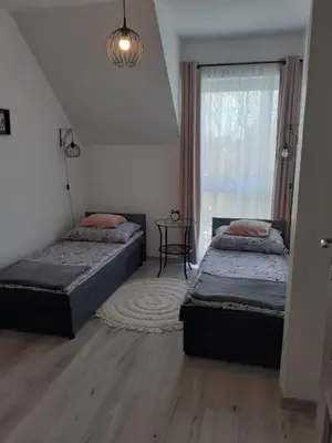 Łóżko lub łóżka w pokoju w obiekcie Apartament w Starym Młynie