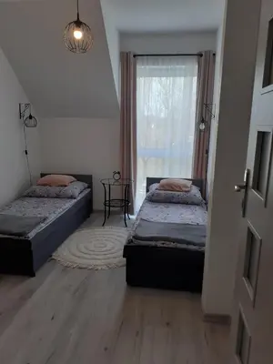 Łóżko lub łóżka w pokoju w obiekcie Apartament w Starym Młynie