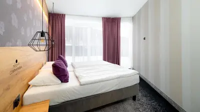 Łóżko lub łóżka w pokoju w obiekcie Aparthotel Czarna Perła - Czarna Góra Resort, Sun & Snow