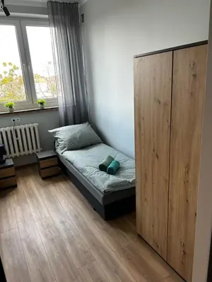 Łóżko lub łóżka w pokoju w obiekcie CZARNA PERŁA