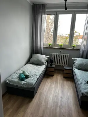 Łóżko lub łóżka w pokoju w obiekcie CZARNA PERŁA
