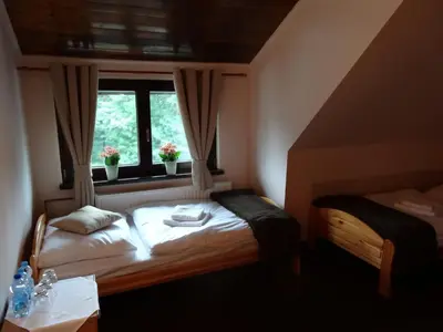 Łóżko lub łóżka w pokoju w obiekcie Zajazd Pod Niedźwiedziem