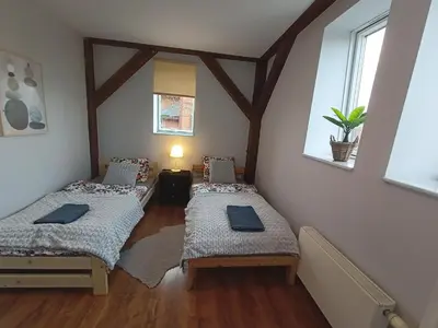 Łóżko lub łóżka w pokoju w obiekcie Lemuria Przytulny pokój Chojnowska
