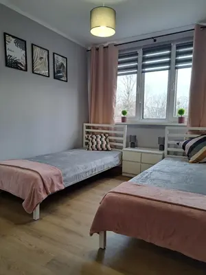Łóżko lub łóżka w pokoju w obiekcie Apartament AQUA Centrum Borowska