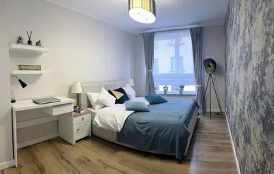 Łóżko lub łóżka w pokoju w obiekcie Rydygiera14