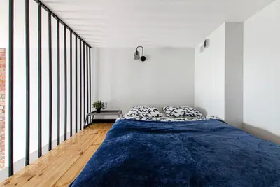 Łóżko lub łóżka w pokoju w obiekcie Loft City Center Apartments- Parking, Wifi, 24h Check-In