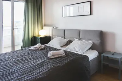 Łóżko lub łóżka w pokoju w obiekcie Ekskluzywny apartament z balkonem
