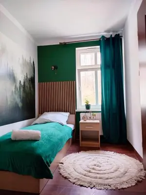 Łóżko lub łóżka w pokoju w obiekcie Dworek Szumilas