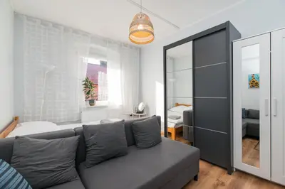 Łóżko lub łóżka w pokoju w obiekcie Apartament Modrzejewska