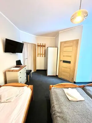 Łóżko lub łóżka w pokoju w obiekcie Willa Sasanka