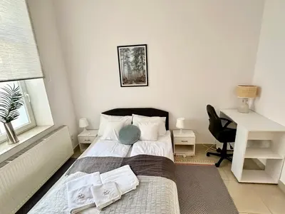 Łóżko lub łóżka w pokoju w obiekcie Komfortowy apartament z tarasem w pobliżu jeziora i Gór Sowich