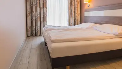 Łóżko lub łóżka w pokoju w obiekcie VacationClub - TIGNES Apartament 6