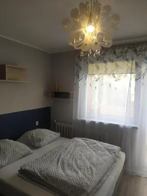 Łóżko lub łóżka w pokoju w obiekcie Studio Niebieskie