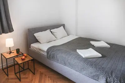 Łóżko lub łóżka w pokoju w obiekcie Klimatyczne gniazdko przy Rynku
