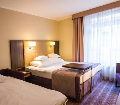 Łóżko lub łóżka w pokoju w obiekcie Hotel DeSilva Premium Opole