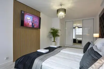 Łóżko lub łóżka w pokoju w obiekcie Apartament Centrum
