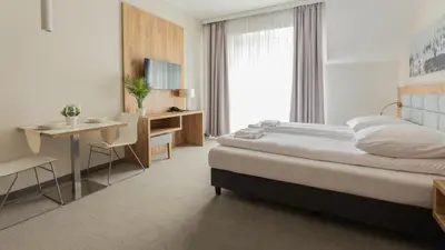 Łóżko lub łóżka w pokoju w obiekcie VacationClub - Aparthotel Czarna Góra, Apartament 339