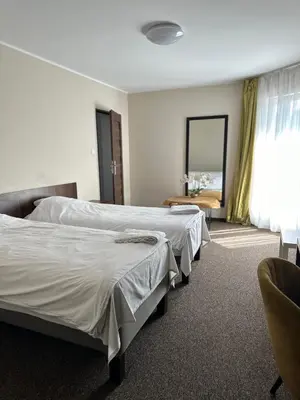 Łóżko lub łóżka w pokoju w obiekcie NOCLEGI Kolonia Wokulskiego 4