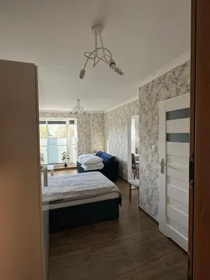 Łóżko lub łóżka w pokoju w obiekcie Wieczorek Apartment