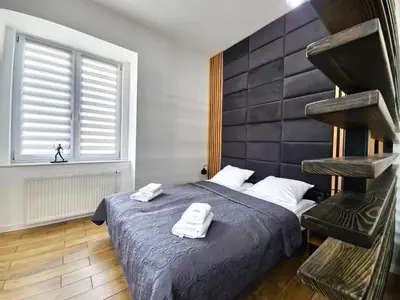 Łóżko lub łóżka w pokoju w obiekcie Wieczorek Apartment