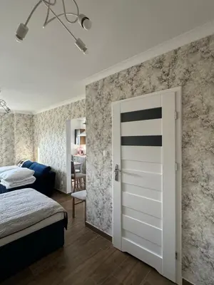 Łóżko lub łóżka w pokoju w obiekcie Wieczorek Apartment