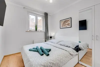 Łóżko lub łóżka w pokoju w obiekcie Apartamenty Franciszkańska