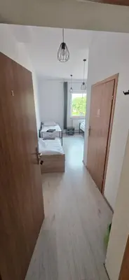 Łóżko lub łóżka w pokoju w obiekcie Średzka Korona