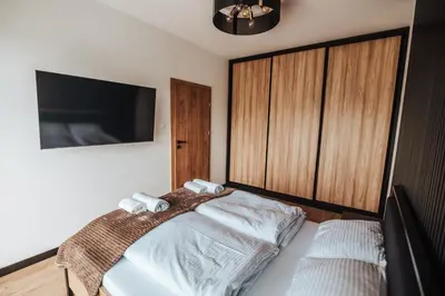 Łóżko lub łóżka w pokoju w obiekcie Apartamenty nad Baryczą