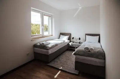 Łóżko lub łóżka w pokoju w obiekcie Apartamenty nad Baryczą