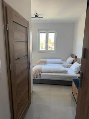 Łóżko lub łóżka w pokoju w obiekcie Apartamenty nad Baryczą