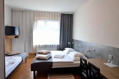 Łóżko lub łóżka w pokoju w obiekcie Hotel Gracja