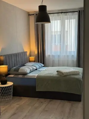 Łóżko lub łóżka w pokoju w obiekcie Brzeska For You II