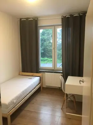 Łóżko lub łóżka w pokoju w obiekcie Hallera Wroclaw