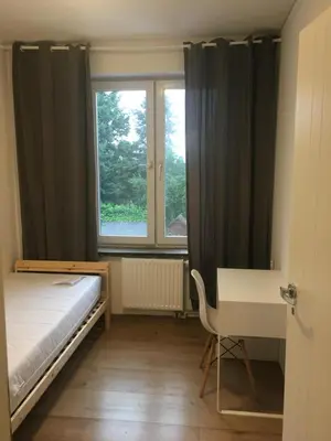Łóżko lub łóżka w pokoju w obiekcie Hallera Wroclaw