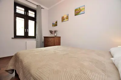 Łóżko lub łóżka w pokoju w obiekcie Słoneczny Apartament przy Rynku