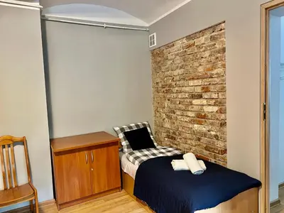 Łóżko lub łóżka w pokoju w obiekcie Tanie Noclegi Puszkina 2