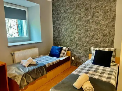 Łóżko lub łóżka w pokoju w obiekcie Tanie Noclegi Puszkina 2