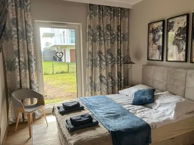 Łóżko lub łóżka w pokoju w obiekcie Apartament Słoneczna polana