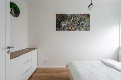 Łóżko lub łóżka w pokoju w obiekcie RentPlanet - Apartament Różanka