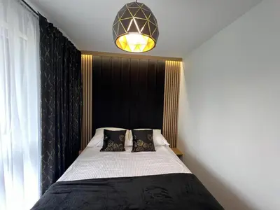 Łóżko lub łóżka w pokoju w obiekcie Apartament Poznańska 2