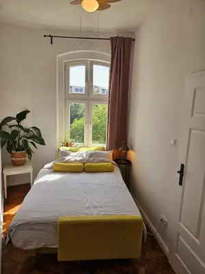 Łóżko lub łóżka w pokoju w obiekcie Apartamenty pod Aniołami