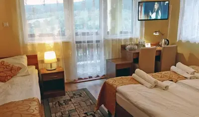 Łóżko lub łóżka w pokoju w obiekcie Pensjonat Zielone Wzgórze w Bolesławowie