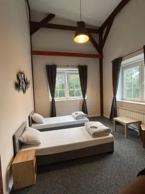 Łóżko lub łóżka w pokoju w obiekcie Młyn Witowice