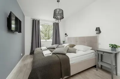 Łóżko lub łóżka w pokoju w obiekcie Apartament Blisko Rzeki Tuż przy Porcie we Wrocławiu z Parkingiem by Noclegi Renters