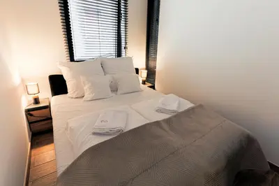 Łóżko lub łóżka w pokoju w obiekcie Hedonia Apartamenty Premium