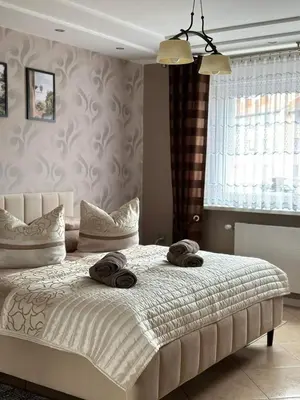 Łóżko lub łóżka w pokoju w obiekcie Pokoje Gościnne U ANI