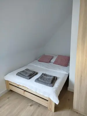 Łóżko lub łóżka w pokoju w obiekcie Apartament Eden