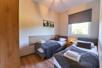 Łóżko lub łóżka w pokoju w obiekcie LAGUNA Loftowy na Wzgórzu