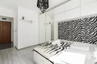 Łóżko lub łóżka w pokoju w obiekcie Apartament Konduktorska z Parkingiem i Ogródkiem - w spokojnej dzielnicy by Noclegi Renters