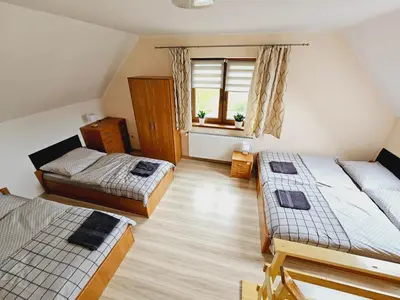 Łóżko lub łóżka w pokoju w obiekcie Apartament pod laskiem